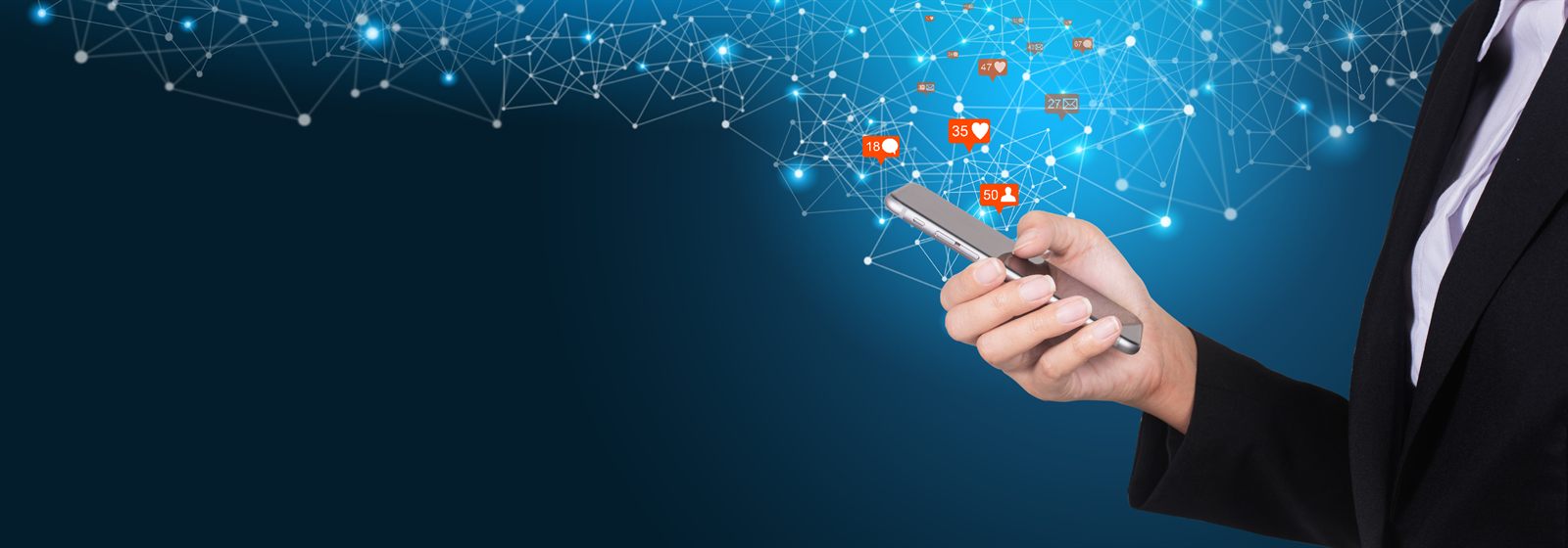 Hand touching glowing icons on a phone screen against a dark blue background