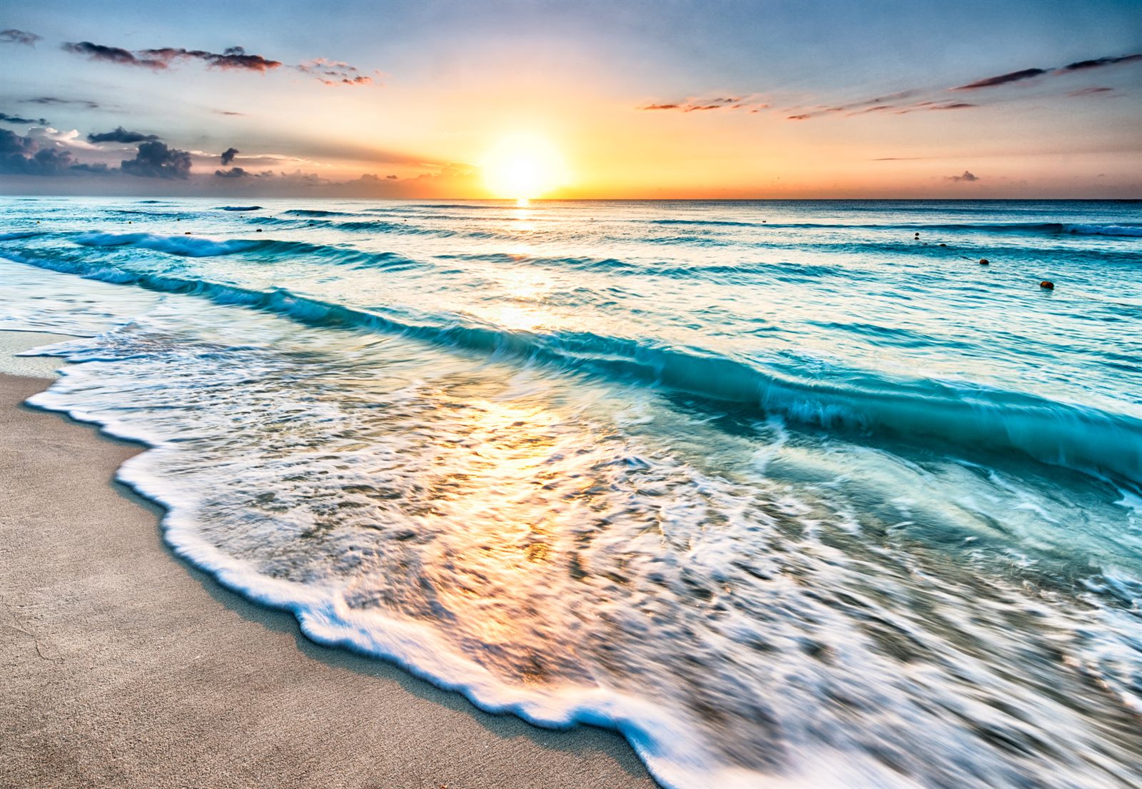 Sunrise over Caribbean surf on a white-sand beach